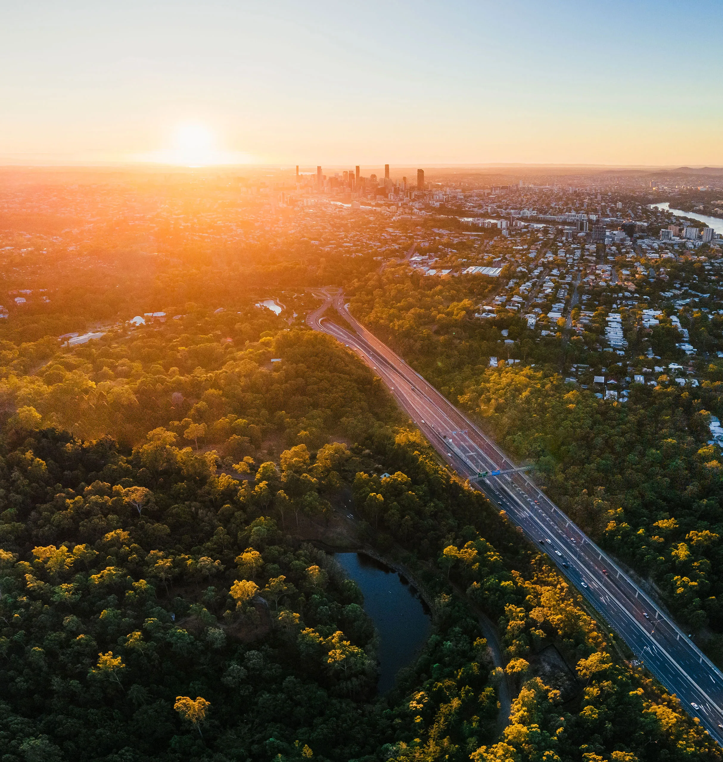 View of Brisbane City with lush green trees around from Mt Cootha